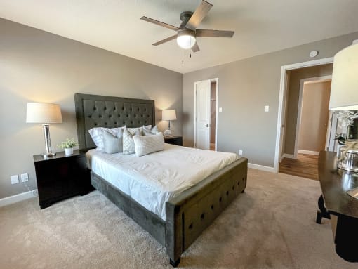 a bedroom with a large bed and a ceiling fan