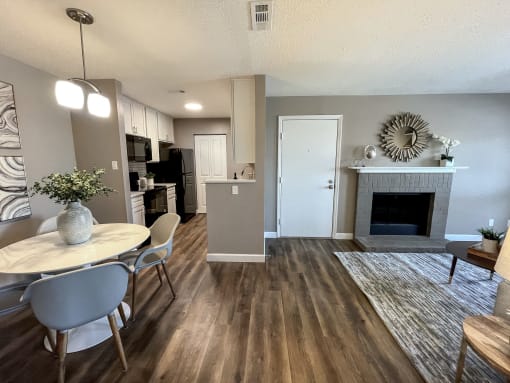 an open living room and dining room with a fireplace and a table