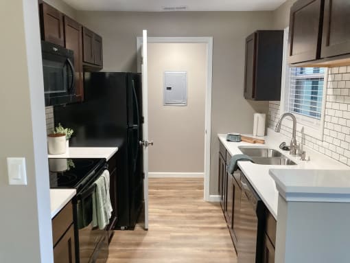 a kitchen with black appliances and a black refrigerator