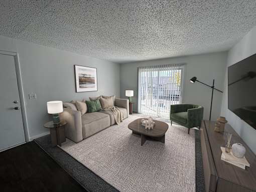 A living room with a grey couch, a green armchair, and a coffee table.