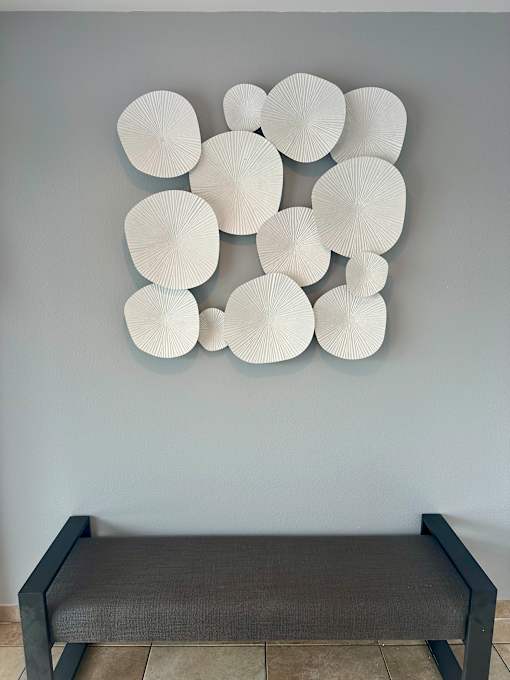 A wall with a series of white circular objects on it.