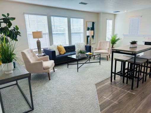 a living room with a couch and chairs and a table