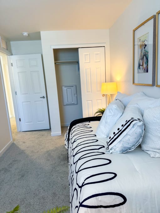 a bedroom with a large bed and a closet