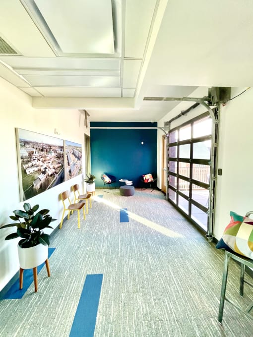 a living room with a blue wall and a large window