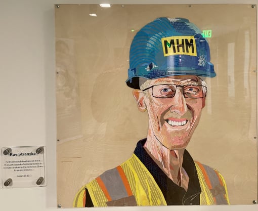a painting of a man wearing a construction hat and a yellow shirt and a blue