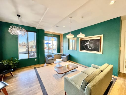 a living room with green walls and a couch and a table