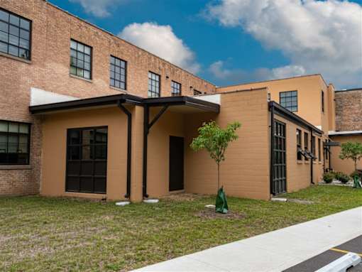 A building with a brown facade and a white awning.