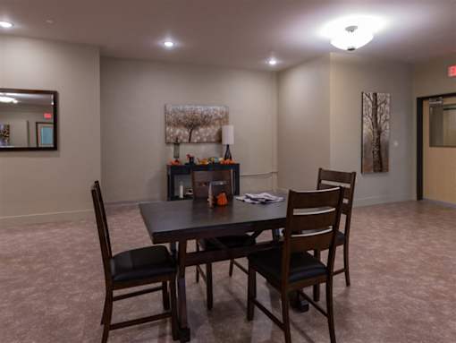A conference room with a table and chairs.