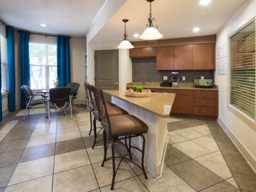a large kitchen with a table and chairs
