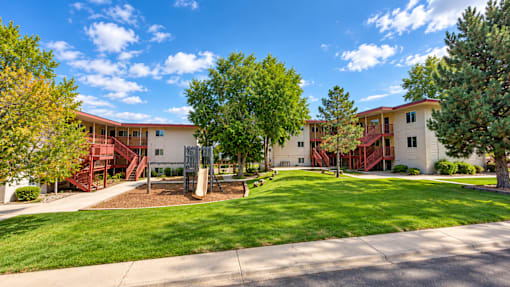 A sunny day at a residential area with houses and greenery.