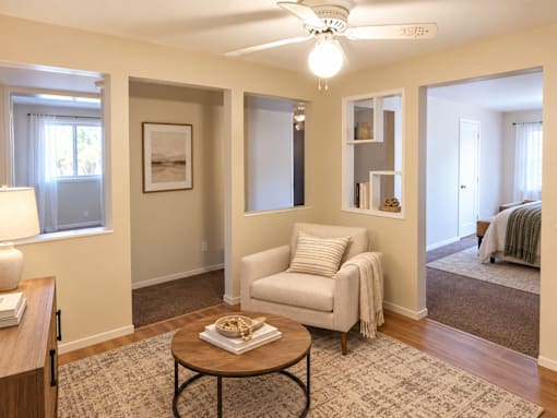 A living room with a white chair and a coffee table.