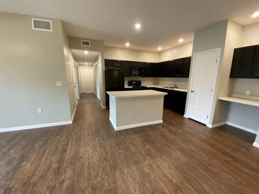 A kitchen with a white island in the middle of the room.