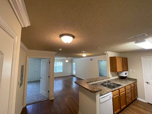A kitchen with a sink, microwave, and cabinets.