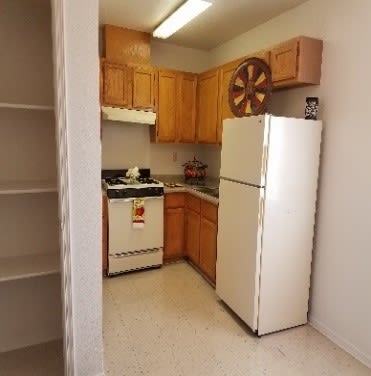 a kitchen with a white refrigerator and a stove