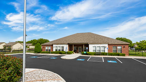 A parking lot with a building in the background.