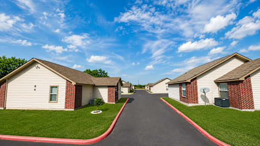 A row of houses with a red line on the sidewalk.