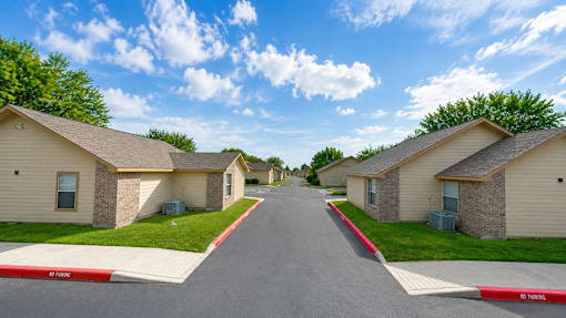 A street view of a residential area with houses on both sides.