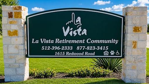 A sign for La Vista Retirement Community with a phone number and address.