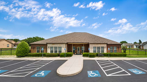 A parking lot with a building and a ramp in front of it.