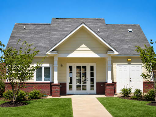 A small house with a white door and windows.