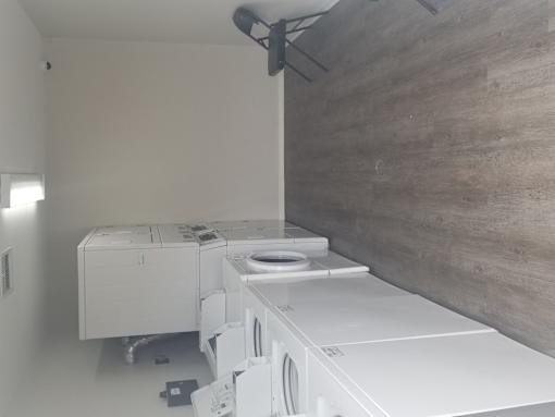 A row of washing machines in a laundromat.