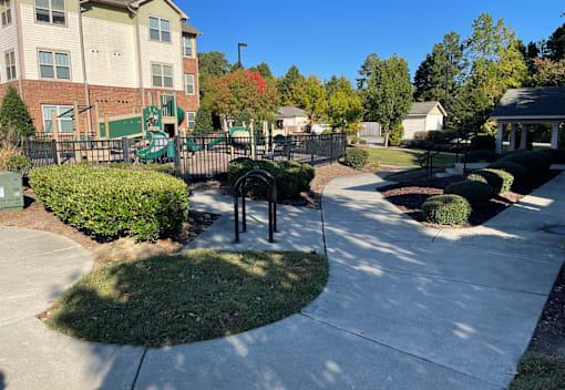 a sidewalk in front of a building with a playground