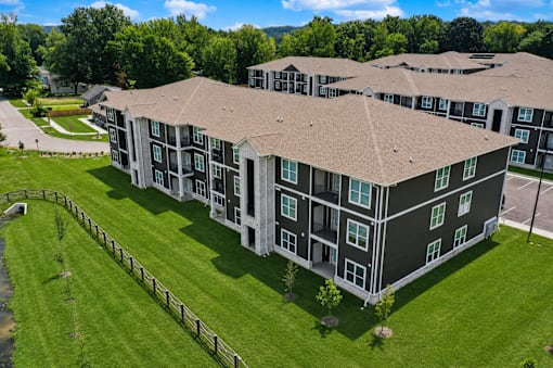A large apartment complex with a green lawn in front.