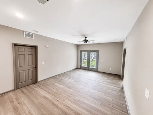 A room with a wooden floor and a ceiling fan.