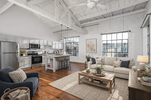 A modern open plan living and kitchen area with a dining table and chairs.