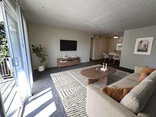 A living room with a grey couch and a coffee table.