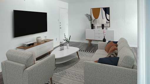 A living room with a grey sofa, a white coffee table, a black television and a painting on the wall.