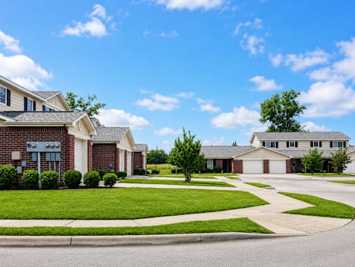 A suburban neighborhood with houses and a clear sky.