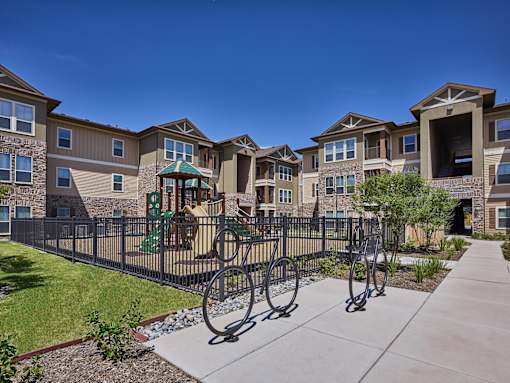A row of houses with a playground in the foreground.