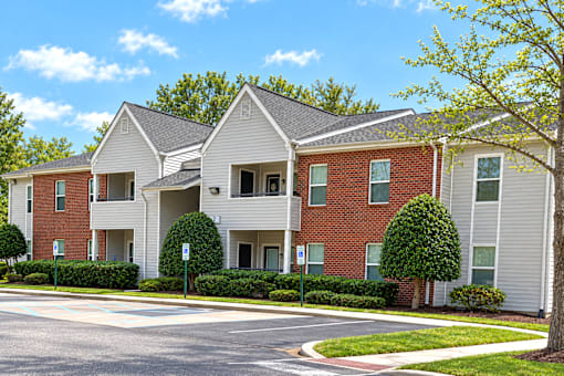 Apartment building with a red brick facade and white trim.