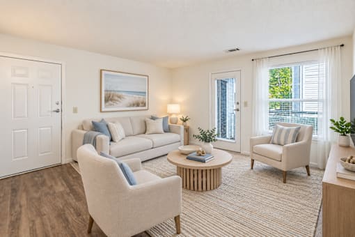 A living room with a couch, chair, and coffee table.