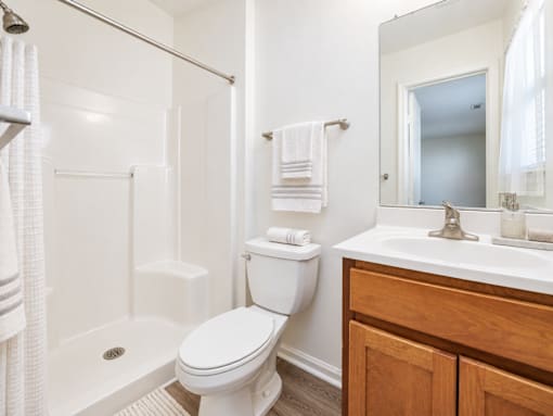 A white toilet sits next to a white sink in a bathroom.
