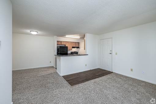 A spacious living room with a television and a countertop.