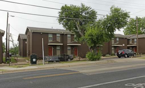 Apartment complex with a car parked in front.
