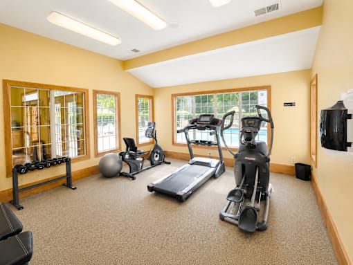 A spacious home gym with a variety of exercise equipment.