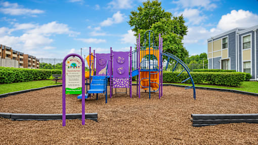 A playground with a purple slide and a sign that says "Playground".