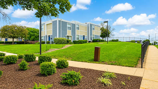 A modern building with a green lawn in front.
