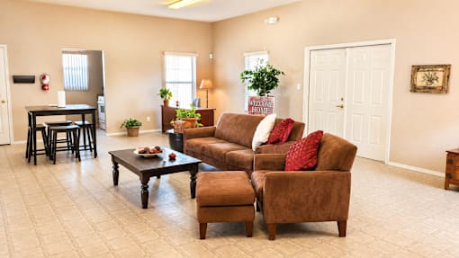 A living room with a brown couch and a coffee table.