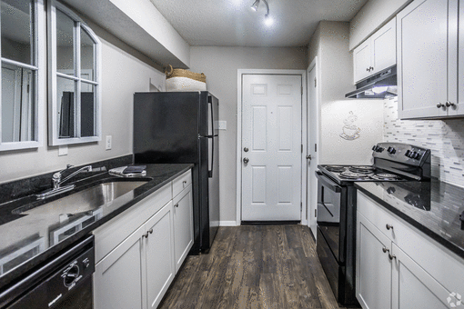 a kitchen with white cabinets and black appliances at Azure Place Apartments, Memphis, at Azure Place Apartments, Tennessee