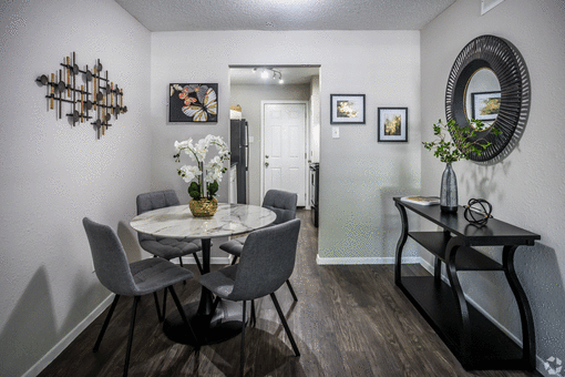 a dining room with a table and chairs at Azure Place Apartments, Memphis, 38118