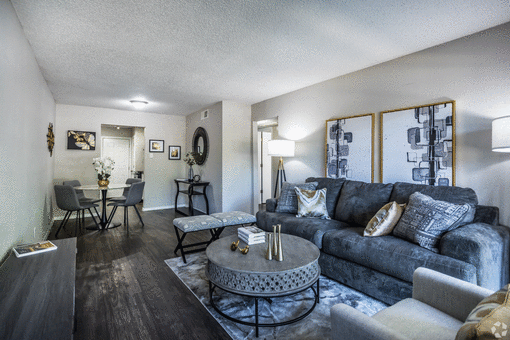 a living room with a large couch and coffee table at Azure Place Apartments, Memphis, TN, 38118