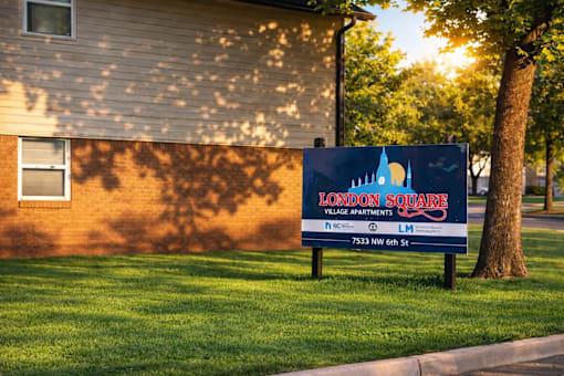 A sign for Shady Oaks Manor is displayed on a grassy area.