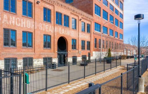 a large brick building with a fence in front of it