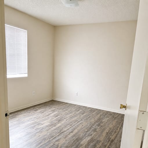 A room with a window and a door.