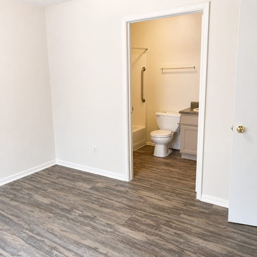 A bathroom with a toilet and a shower.