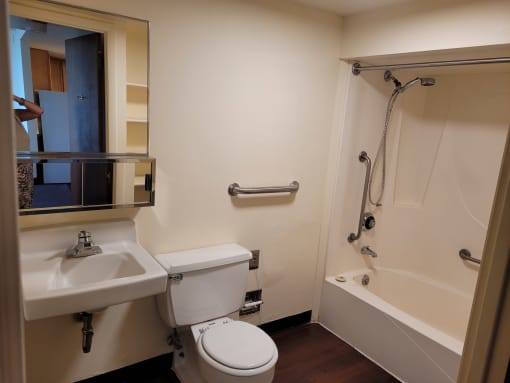 an empty bathroom with a toilet sink and bathtub